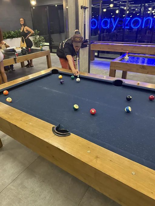 Friend lining up a shot on a pool table